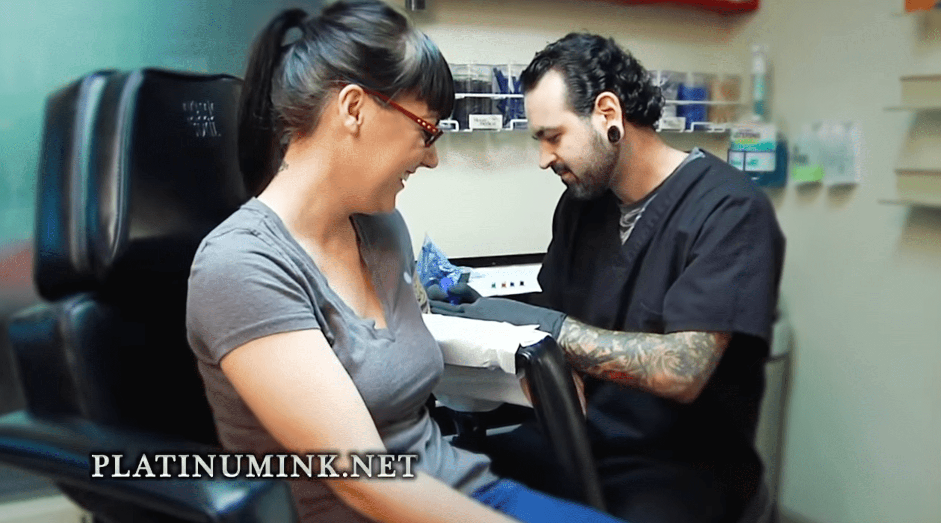 tattoo artist make a tatto on girl arm