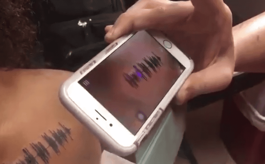 a phone scanning a Voicemail tattoo