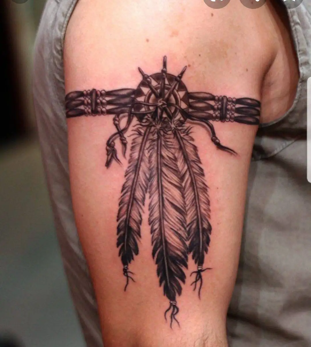 Feather tattoo on biceps