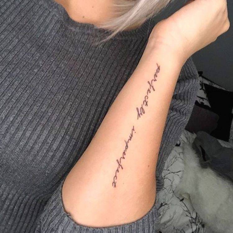 Perfectly imperfect tattooed on arm