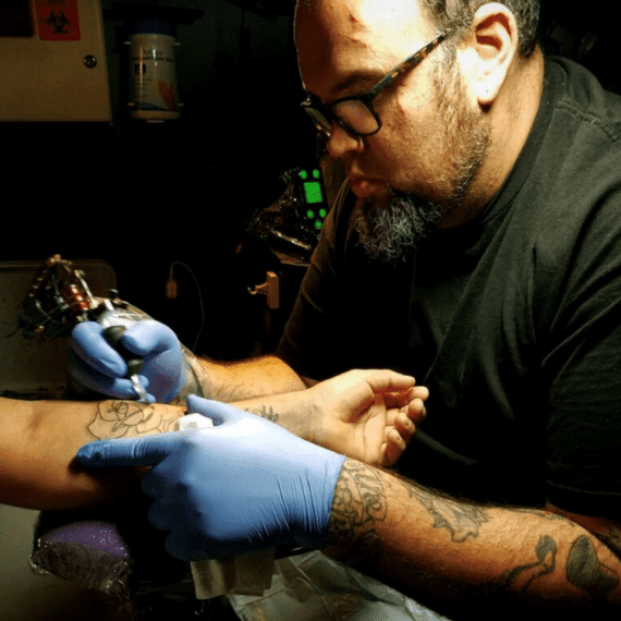 A Tattoo Artist Making A Tattoo On Arm